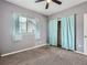 Bedroom features neutral carpet, window with blinds, and a closet with curtains at 11250 Florence St # 20B, Commerce City, CO 80640