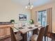 Elegant dining room with neutral tones, art and sliding glass door at 11250 Florence St # 20B, Commerce City, CO 80640