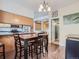 Dining table adjacent to kitchen with chandelier and open floor plan at 11250 Florence St # 20B, Commerce City, CO 80640