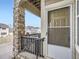 Welcoming townhouse entrance with a stone pillar accent and a storm door at 11250 Florence St # 20B, Commerce City, CO 80640