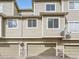 Multi-car garage with neutral doors and stone accents on a well maintained building at 11250 Florence St # 20B, Commerce City, CO 80640