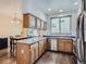 Open kitchen with wood cabinets, counter, stainless dishwasher and sink at 11250 Florence St # 20B, Commerce City, CO 80640