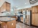 Well-equipped kitchen with stainless steel appliances and wood cabinets at 11250 Florence St # 20B, Commerce City, CO 80640