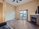 Bright living area featuring a fireplace, sliding glass doors, and a high, vaulted ceiling at 11250 Florence St # 20B, Commerce City, CO 80640