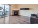 Relaxing living room boasting hardwood floors, fireplace, and access to outdoor balcony at 11250 Florence St # 20B, Commerce City, CO 80640
