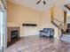Spacious living room with a cozy fireplace, hardwood floors, and easy access to dining area at 11250 Florence St # 20B, Commerce City, CO 80640