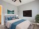 Cozy main bedroom showcasing soft bedding, neutral carpet, and a mounted TV at 11250 Florence St # 20B, Commerce City, CO 80640