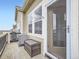 Cozy patio area with wooden deck, storage, and entrance to the house with large windows at 11250 Florence St # 20B, Commerce City, CO 80640