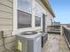 Exterior patio showcasing large windows, storage options, and an air conditioning unit at 11250 Florence St # 20B, Commerce City, CO 80640