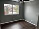 Bedroom with hard wood flooring, a ceiling fan, and a window at 20328 E Powers Ln, Aurora, CO 80015