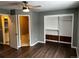 Bedroom featuring hard wood floors, a ceiling fan, an ensuite bathroom and a closet at 20328 E Powers Ln, Aurora, CO 80015
