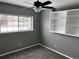 Bedroom features gray walls, plush carpet, a ceiling fan, built-in shelving, and a window providing natural light at 20328 E Powers Ln, Aurora, CO 80015