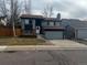 Charming two-story home with gray siding, brick accents, attached garage, and freshly landscaped front yard at 20328 E Powers Ln, Aurora, CO 80015