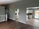 Living room with hard wood flooring and neutral paint, next to the kitchen at 20328 E Powers Ln, Aurora, CO 80015