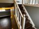 Staircase with dark wood treads, white risers and railings, leading to an upper level with gray walls at 20328 E Powers Ln, Aurora, CO 80015