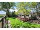 Backyard view shows a tiered wood deck, mature landscaping, and view of neighboring open space at 7582 Powderhorn Dr, Lone Tree, CO 80124