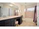 Bathroom with vanity, ample counter space, and shower-tub combo at 7582 Powderhorn Dr, Lone Tree, CO 80124