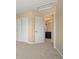 Bedroom with neutral carpeting, closet and bathroom access at 7582 Powderhorn Dr, Lone Tree, CO 80124