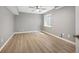 Bedroom features a window, wood flooring, and neutral paint at 7582 Powderhorn Dr, Lone Tree, CO 80124