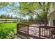 Spacious wooden deck overlooks a lush backyard and beautiful open space with mature trees at 7582 Powderhorn Dr, Lone Tree, CO 80124