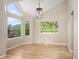 Bright dining area with hardwood floors and expansive windows overlooking open space and green grass at 7582 Powderhorn Dr, Lone Tree, CO 80124