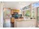 Bright kitchen features stone counters, stainless appliances, and access to an outdoor patio at 7582 Powderhorn Dr, Lone Tree, CO 80124