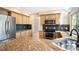 Bright kitchen boasts stainless steel appliances, granite countertops, and wooden cabinets at 7582 Powderhorn Dr, Lone Tree, CO 80124