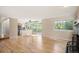 Open floor plan with hardwood floors connecting the living room to the eat-in kitchen at 7582 Powderhorn Dr, Lone Tree, CO 80124