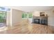 Bright living room with hardwood floors, gas fireplace, and access to an outdoor patio at 7582 Powderhorn Dr, Lone Tree, CO 80124