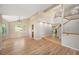 Open-concept living room featuring hardwood floors, vaulted ceilings, and abundant natural light at 7582 Powderhorn Dr, Lone Tree, CO 80124