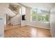 Sun-filled living room showcasing hardwood floors, staircase, and expansive windows with great views at 7582 Powderhorn Dr, Lone Tree, CO 80124