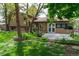 Beautiful backyard with lush lawn, landscaping, and partial view of the home at 8793 E Monmouth Pl, Denver, CO 80237