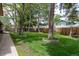 Beautiful green backyard with mature trees and a wooden fence perimeter at 8793 E Monmouth Pl, Denver, CO 80237