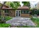 Well-maintained backyard patio area with garden beds and double glass doors to the home at 8793 E Monmouth Pl, Denver, CO 80237