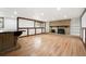 Spacious basement with wood floors, a fireplace, and a bar area at 8793 E Monmouth Pl, Denver, CO 80237