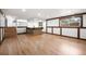 Spacious basement with wood floors, a bar area, and natural light at 8793 E Monmouth Pl, Denver, CO 80237