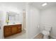 Bathroom features a wood vanity with tan tile flooring and a step-in shower at 8793 E Monmouth Pl, Denver, CO 80237