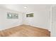 Bedroom featuring hardwood floors, white walls, and a window at 8793 E Monmouth Pl, Denver, CO 80237