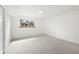Carpeted bedroom featuring white walls, a window, and a closet at 8793 E Monmouth Pl, Denver, CO 80237