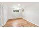 Bedroom featuring hardwood floors, white walls, and a closet at 8793 E Monmouth Pl, Denver, CO 80237