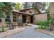 Inviting home with a brick exterior, two rocking chairs, and attractive landscaping, exuding warmth and curb appeal at 8793 E Monmouth Pl, Denver, CO 80237