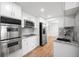 Well-equipped kitchen with white cabinets, stainless steel appliances, granite countertops, and hardwood floors at 8793 E Monmouth Pl, Denver, CO 80237