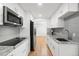 Galley kitchen features granite countertops, stainless appliances, and white cabinets at 8793 E Monmouth Pl, Denver, CO 80237