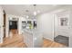 Kitchen island with granite countertop, stainless appliances, and hardwood floors at 8793 E Monmouth Pl, Denver, CO 80237