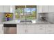 Bright kitchen with backyard views, granite counters, stainless sink and modern faucet at 8793 E Monmouth Pl, Denver, CO 80237