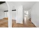 Bright open living space with hardwood floors, white walls, and a unique arched doorway at 8793 E Monmouth Pl, Denver, CO 80237
