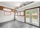 Bright sunroom with tile flooring and french doors to the backyard at 8793 E Monmouth Pl, Denver, CO 80237