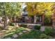Serene backyard featuring a wooden deck, mature trees, and a well-manicured lawn, perfect for relaxation at 815 Gaylord St, Denver, CO 80206