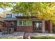 Inviting backyard with a wooden deck, outdoor dining area, and mature trees offering shade and privacy at 815 Gaylord St, Denver, CO 80206