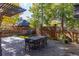 Spacious wooden deck perfect for outdoor entertaining, surrounded by lush landscaping and a charming fence at 815 Gaylord St, Denver, CO 80206